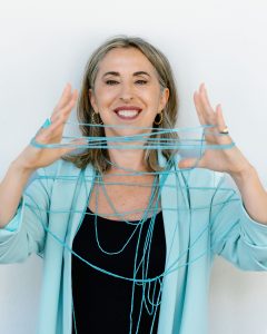 Mujer de mediana edad con sonrisa genuina hablando por teléfono